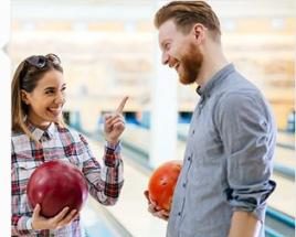 pretty woman and man bowling