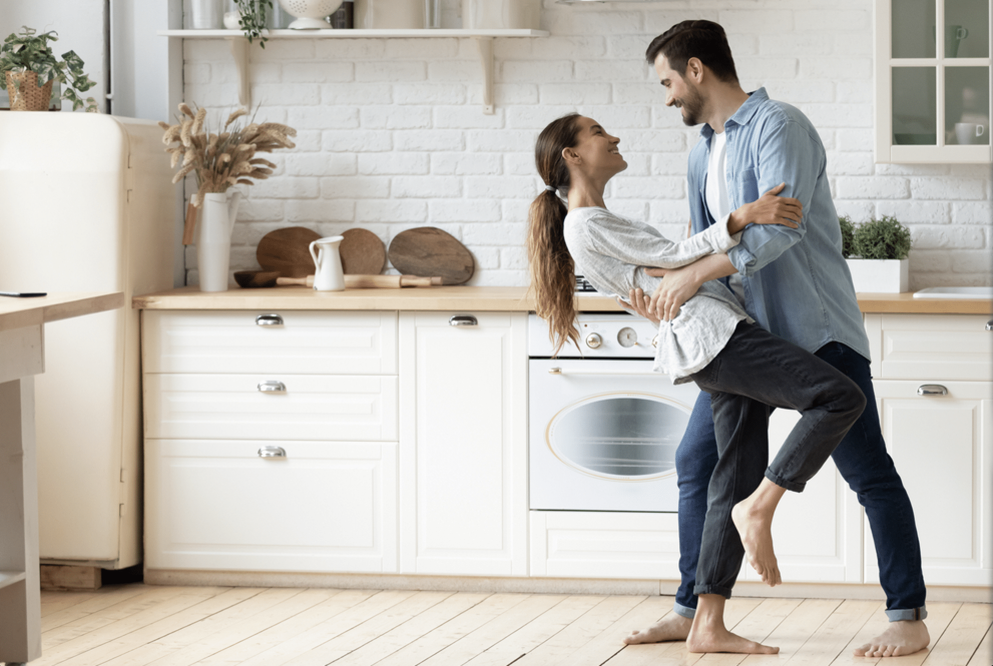 a happy couple dancing in the kitchen