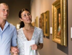 A couple strolling through an art museum.