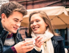 Man in woman having coffee in cold weather.