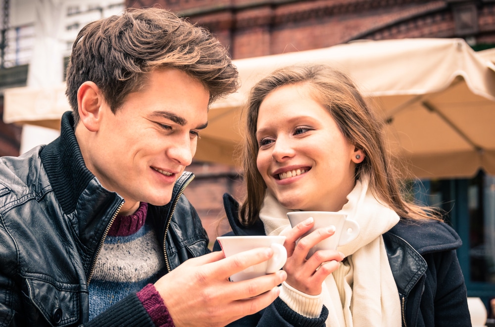 Man in woman having coffee in cold weather.